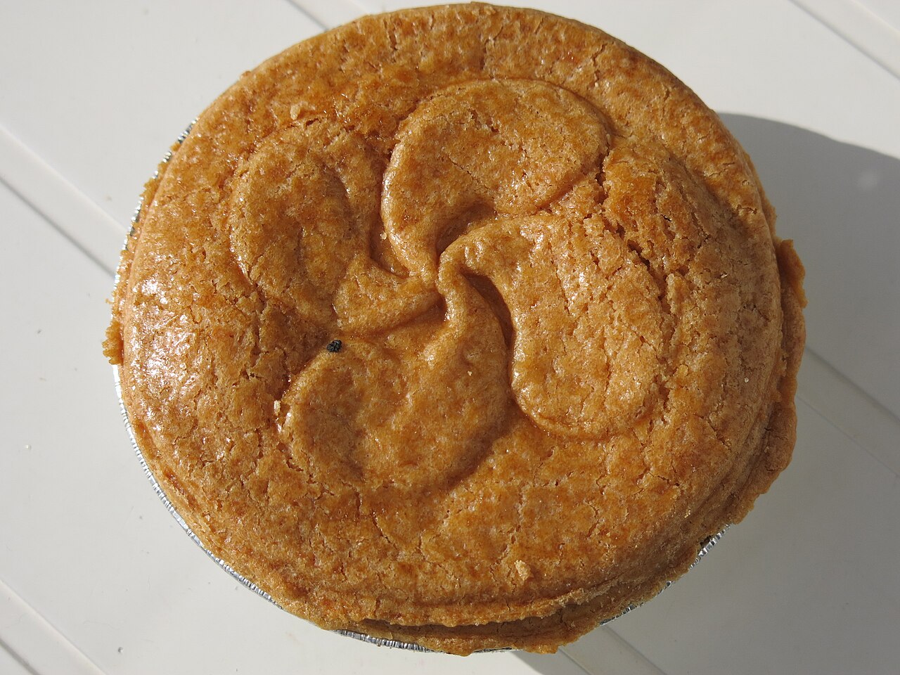 Gateau basque with Lauburu (basque cross).