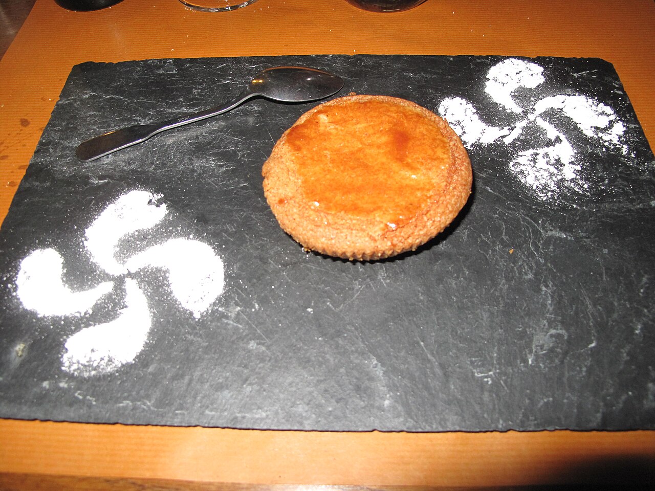 Cake of the basque country, with decorations made with sugar powder in shape of basque crosses (lauburu). In the restaurant "Hostellerie du chateau" in Mauléon-Licharre (Pyrénées-Atlantiques, France).