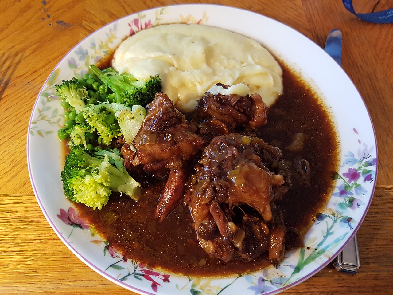 Oxtail stew, mashed potato and broccoli