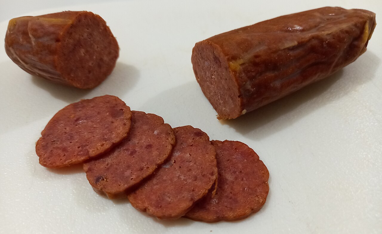 An example of chorizo de bilbao of King Sue brand. Thin sliced pieces were made to present the contents and cross-section of the sausage. The example provided is cold from being kept in the refrigerat