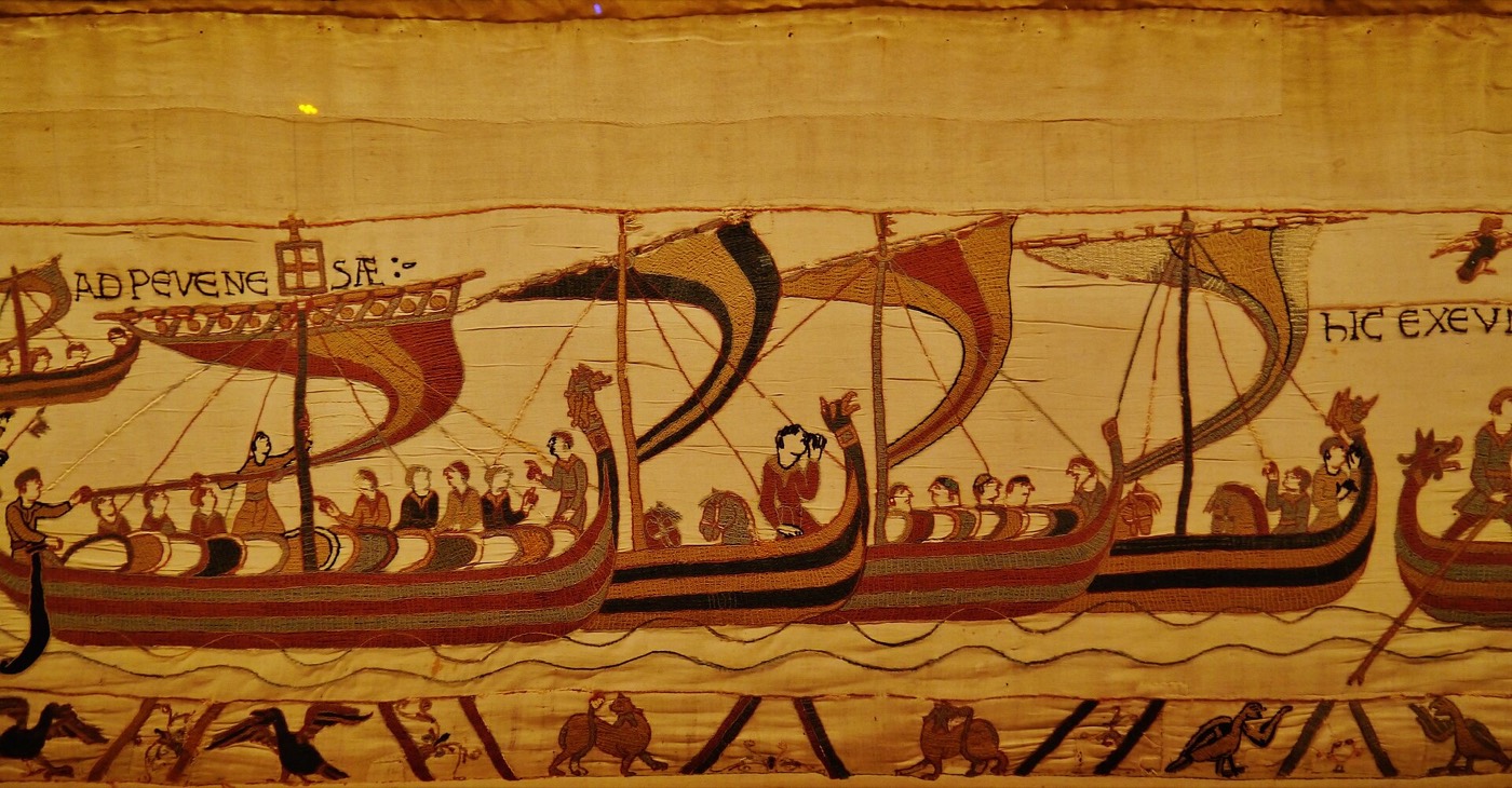 Scene 38 in the dim gallery at Bayeux: the fleet lands at Pevensey.