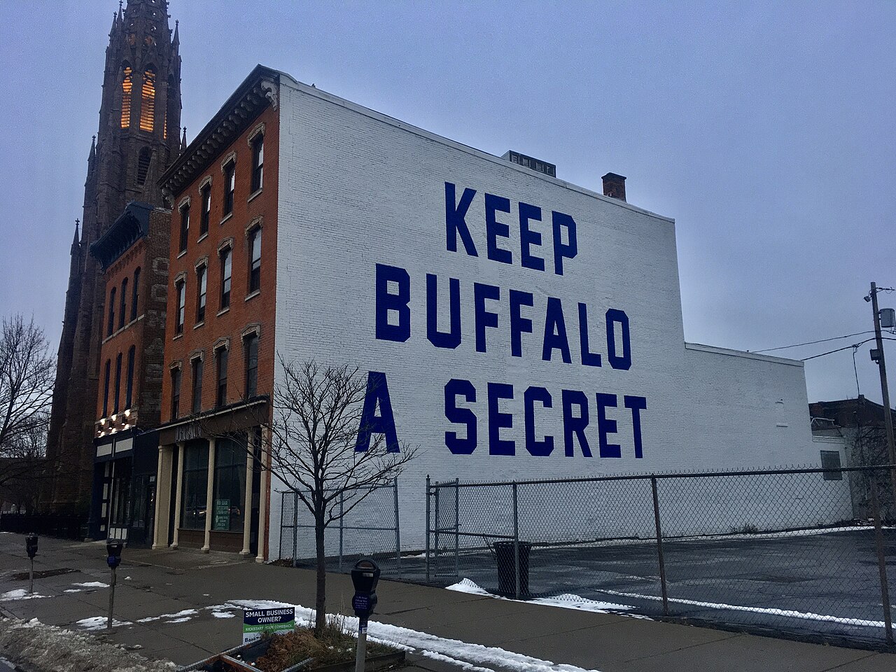 The controversial motto "KEEP BUFFALO A SECRET" - made well-known by the locally-based Oxford Pennant Company - is seen as a mural on the north side of the building at 810 Main Street, in the Allentow