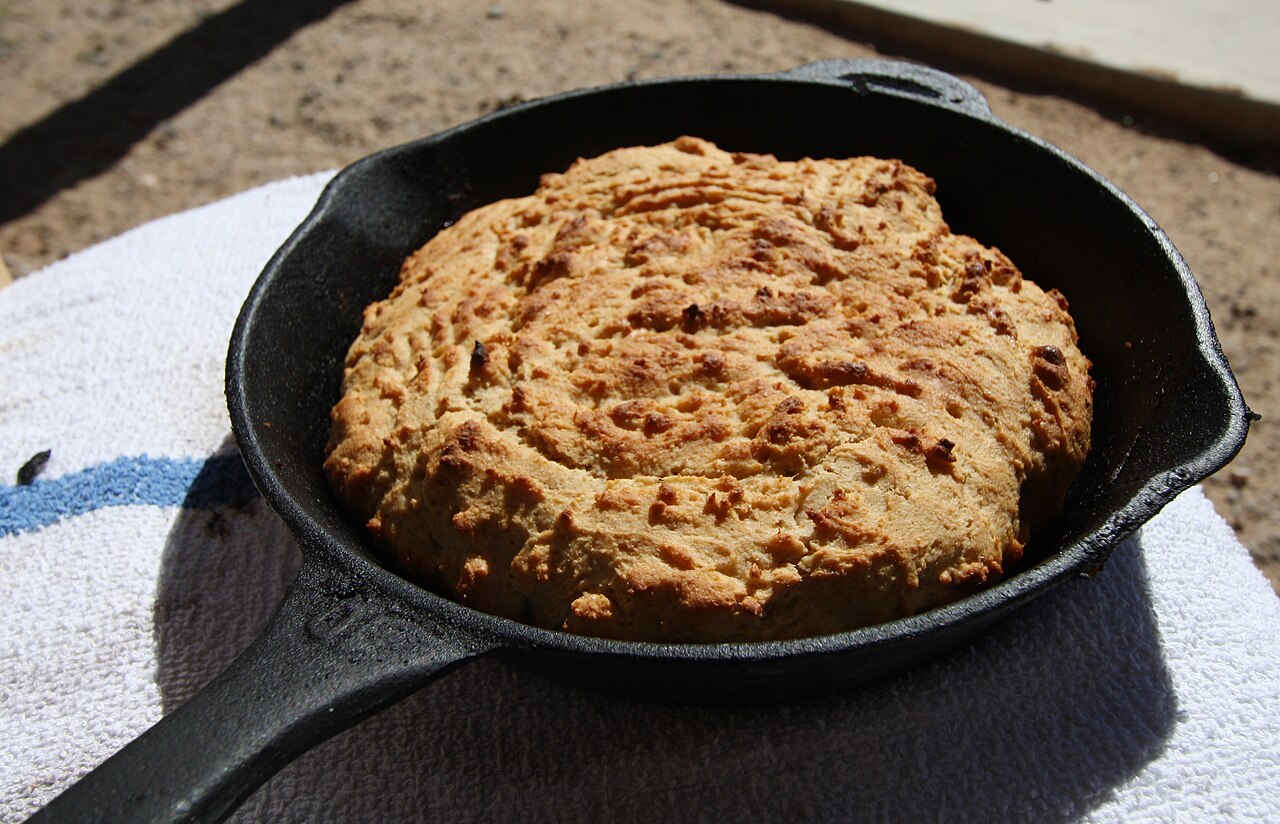 Cornbread cooked in a cast iron skillet.