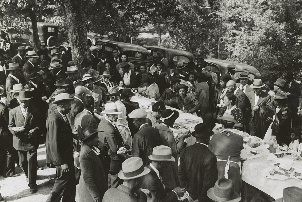 An outdoor picnic held during the noon intermission of an all-day meeting of ministers and deacons at a church near Yanceyville, Caswell County, North Carolina, 1940.
