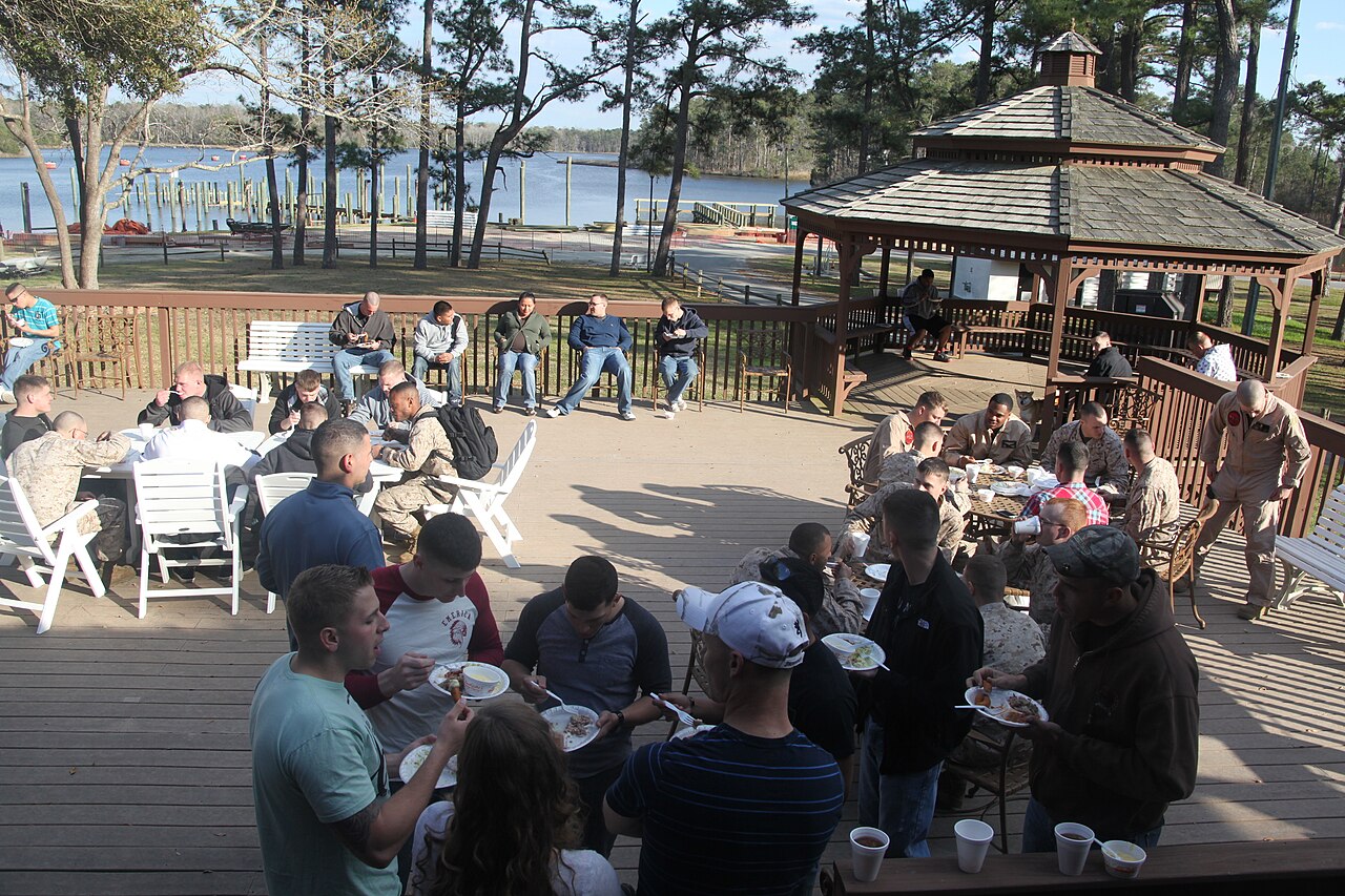 Marines, Sailors and their families enjoy a free dinner from the leaders of the local community during the Havelock Military Affairs Committee’s Pig Pickin at Hancock Marina March 27. More than 200 re