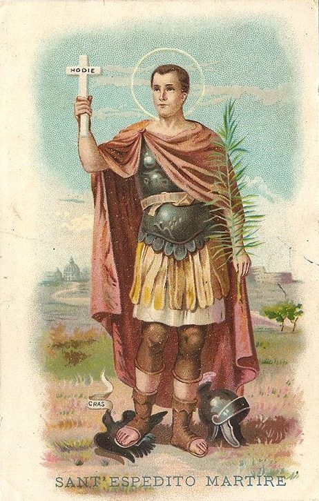 Holy card, Milan 1897: Saint Expedite in Roman armour holds a cross marked HODIE; under his sandal a crow's ribbon reads CRAS.