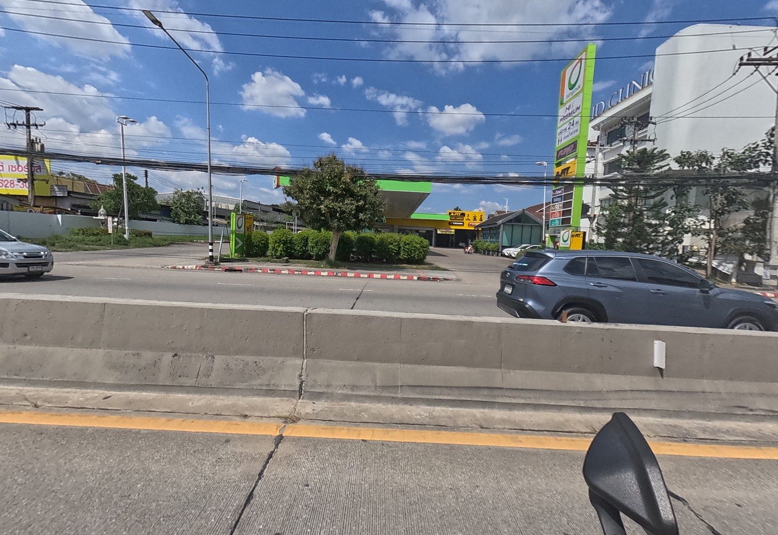 Across the road, a Bangchak station with an A-FIT service bay, and UD Clinic at right.