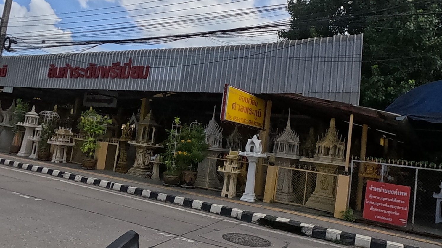 Roadside spirit-house shop, rows of ornate shrines for sale