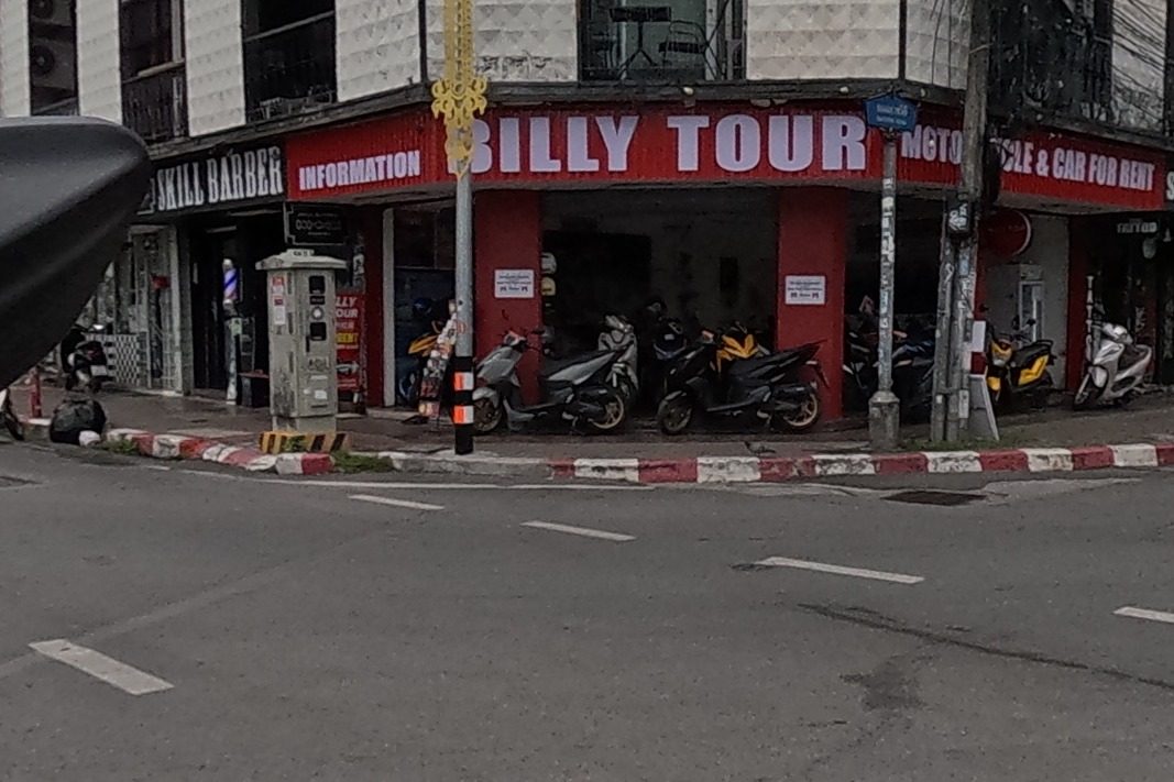 A motorbike rental and tour shop, a tattoo studio, and an organic spa salon at the far corner.