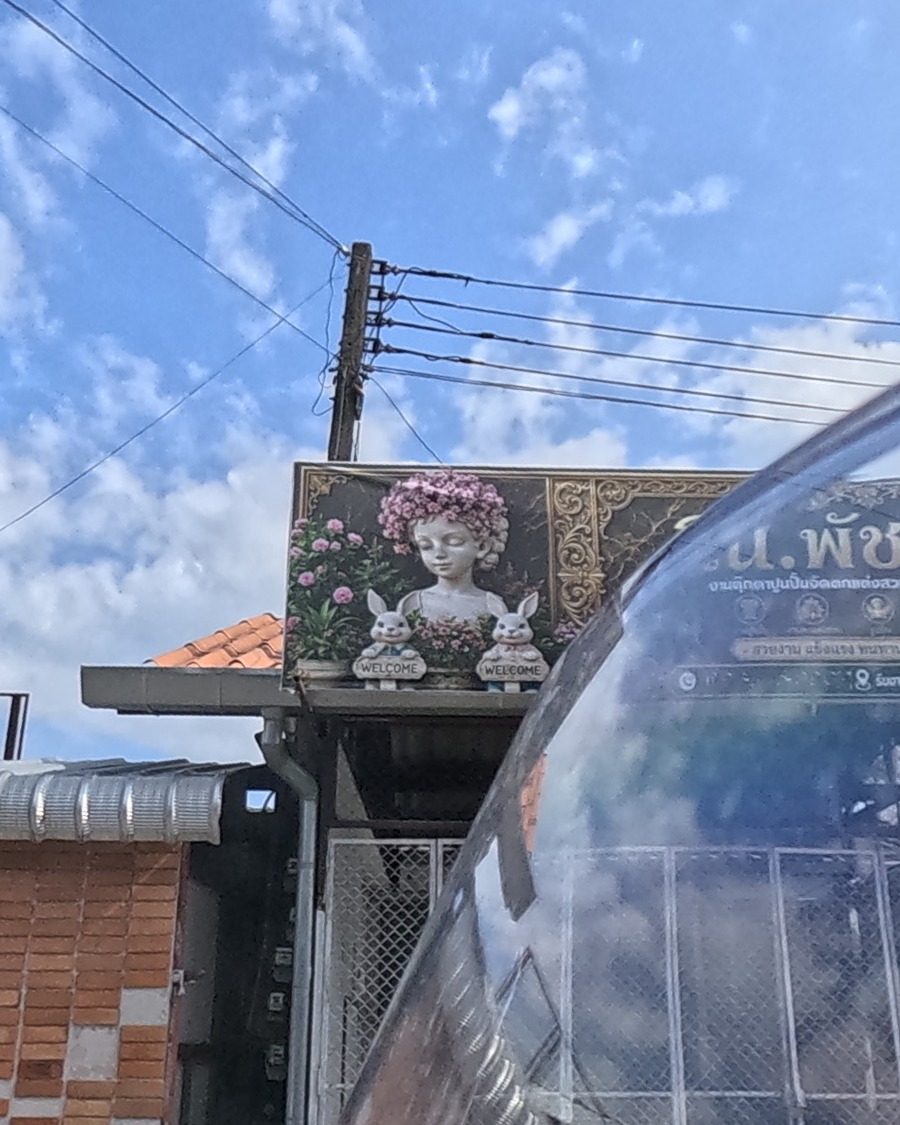 Garden statue shop sign, girl and rabbits