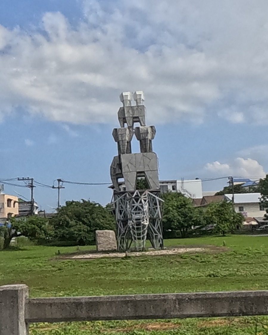 Abstract stacked-figure sculpture on the green