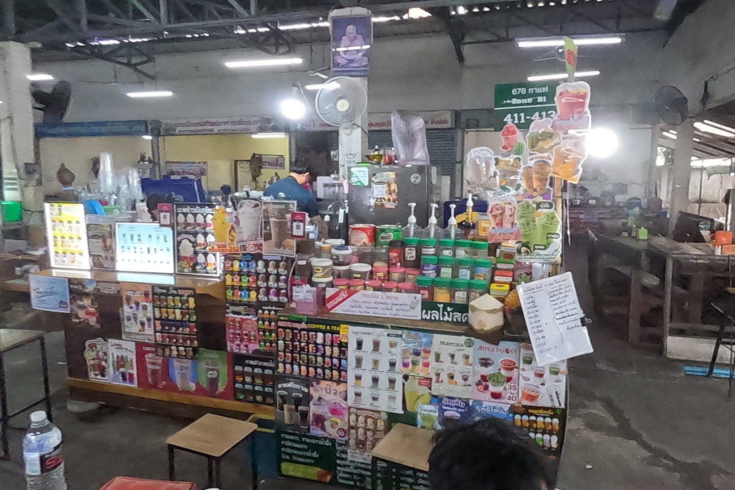 A drinks stall covered in menu pictures