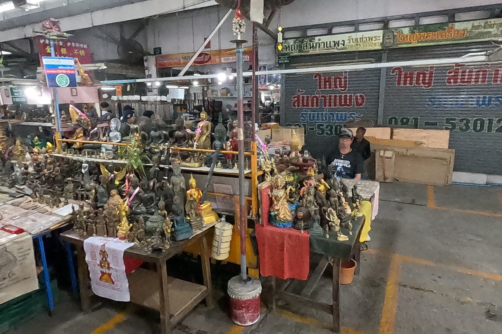 A statue stall under a tiered parasol