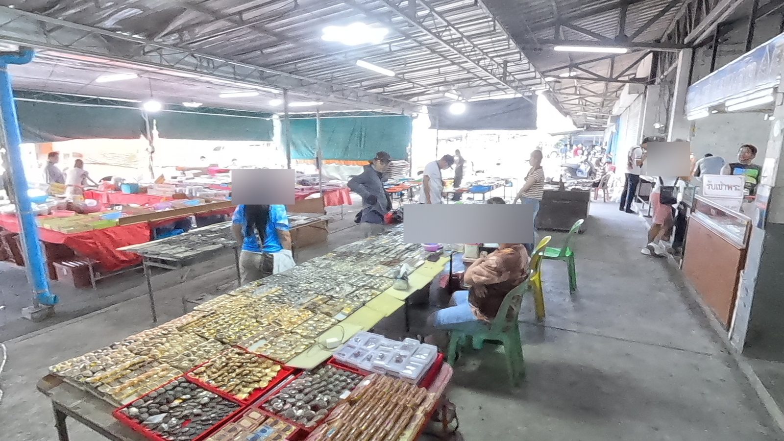 Tables of gold-cased amulets in the outer aisle