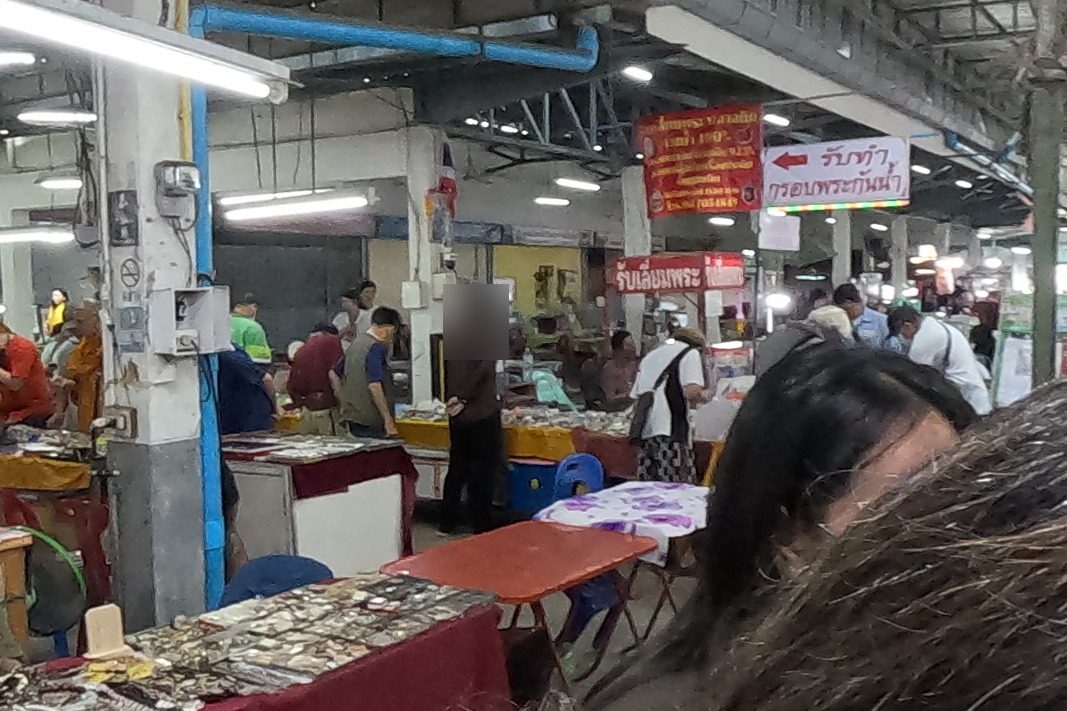 Monks browse the amulet tables