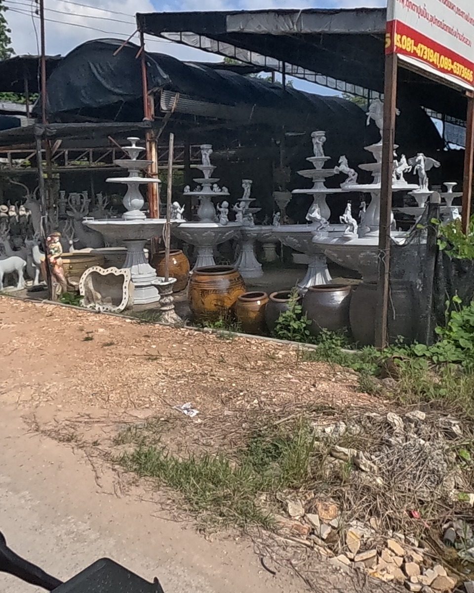 Concrete fountains and garden statues in rows