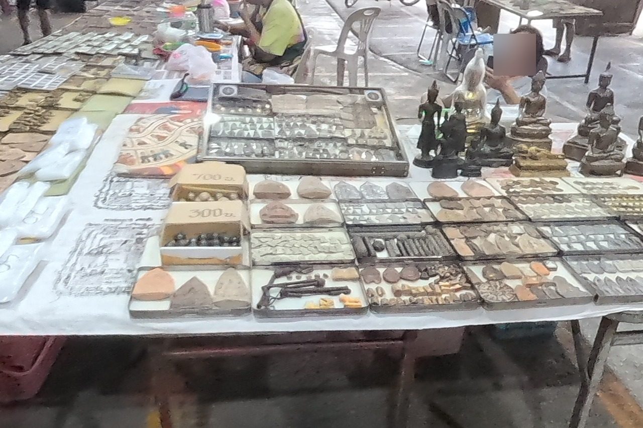 Amulet tins, yant cloths and bronze Buddha images with price cards