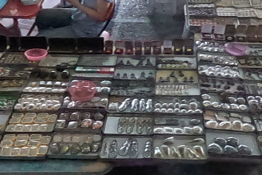 Trays of small amulets in plastic packs