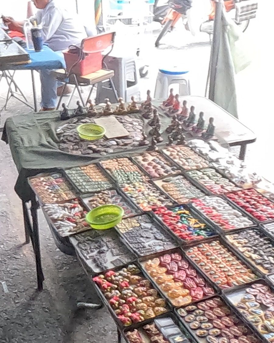 Cased amulets and small monk figures