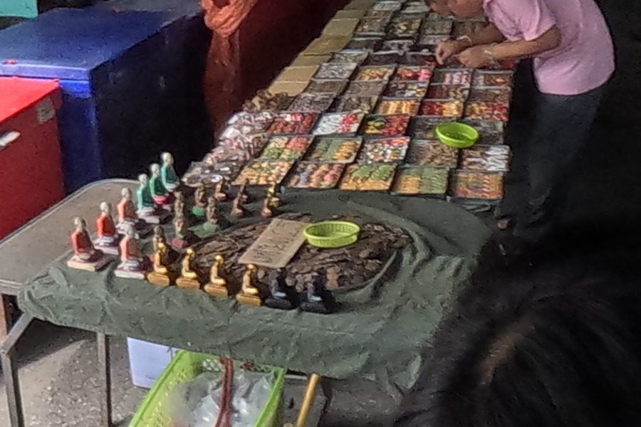 Boxed amulets and small monk statuettes