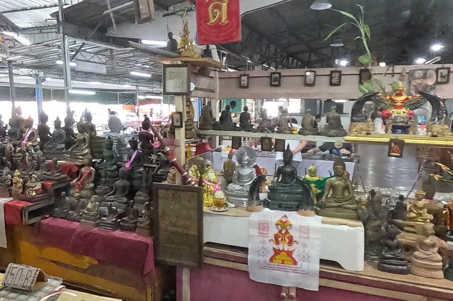 A stall of Buddha images and a Garuda