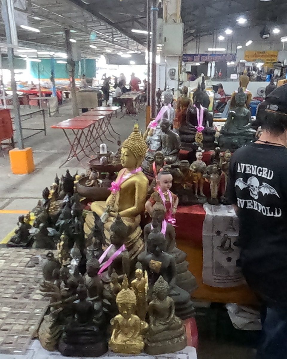 Buddha images tied with pink ribbons