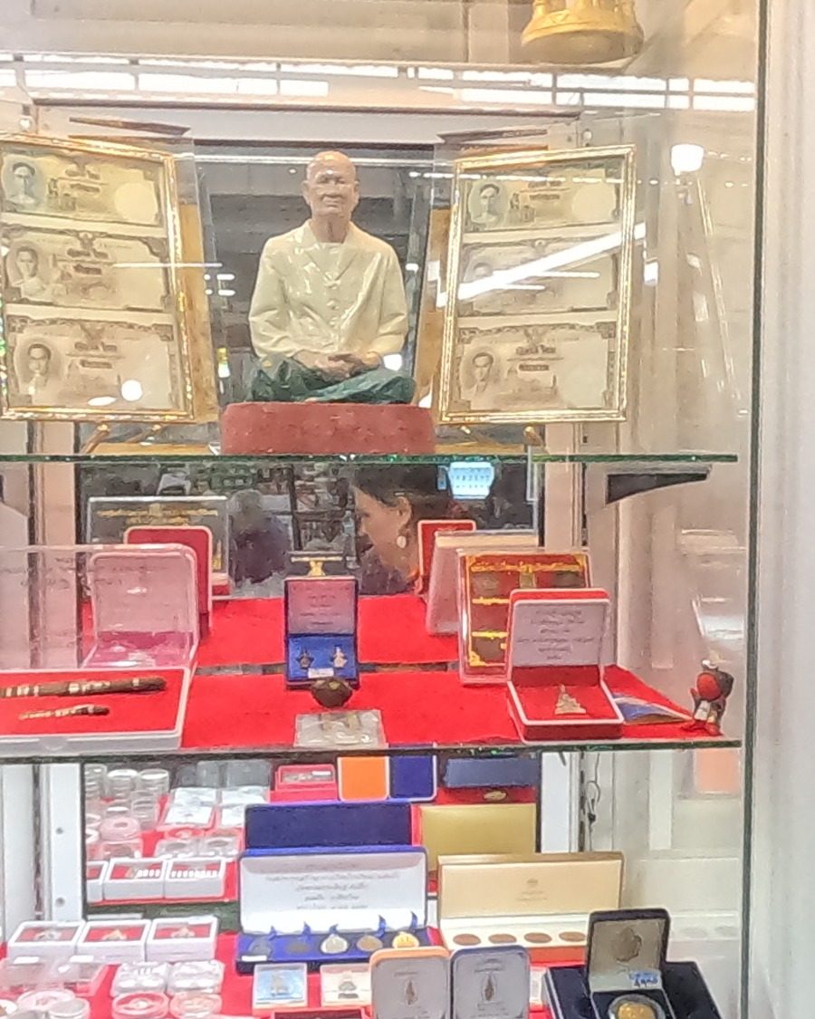 Monk figure, old banknotes and boxed coins