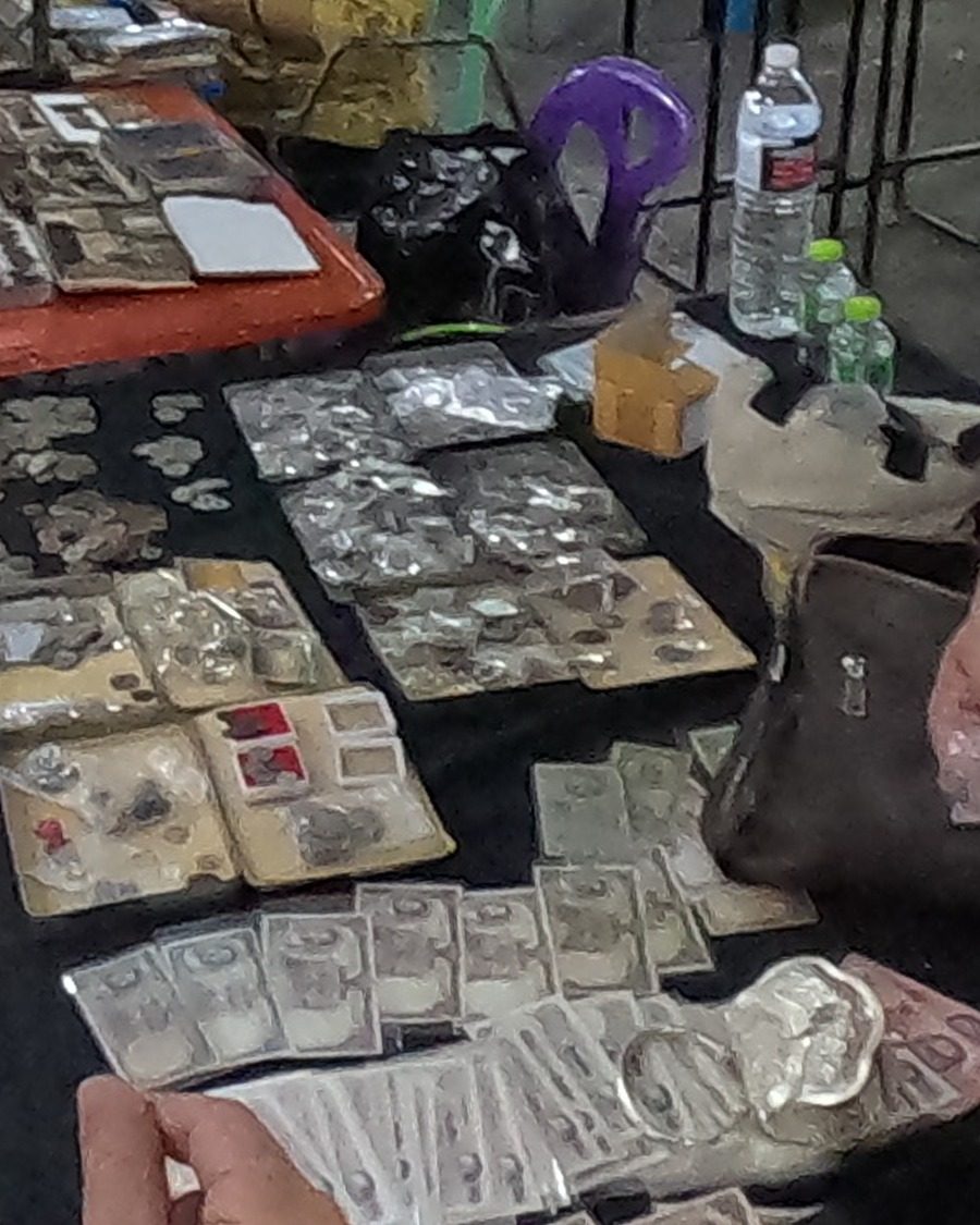 Old coins and banknotes on black cloth