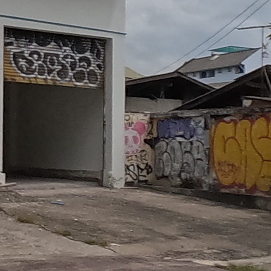 Pink skull graffiti panel with tags