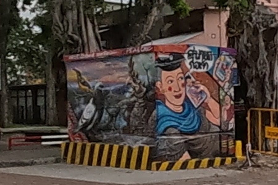 Hand-painted postal box: mailman with letter and hornbill