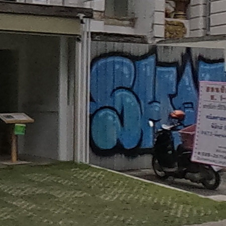 Blue bubble-letter throw-up tag on wall