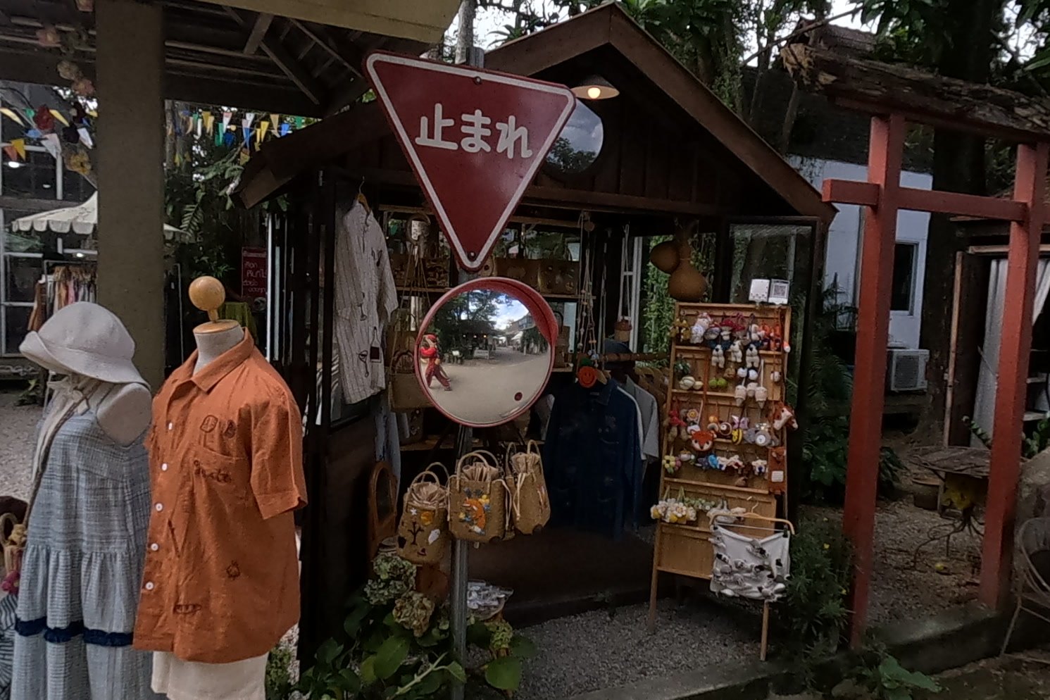 A Japanese stop sign and torii at a clothes booth — Chamcha Market, San Kamphaeng
