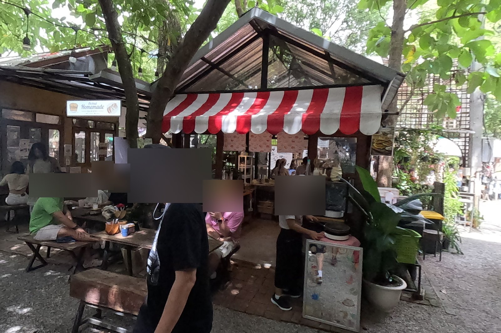 Red-and-white awning snack stall and bakery tables — Chamcha Market, San Kamphaeng