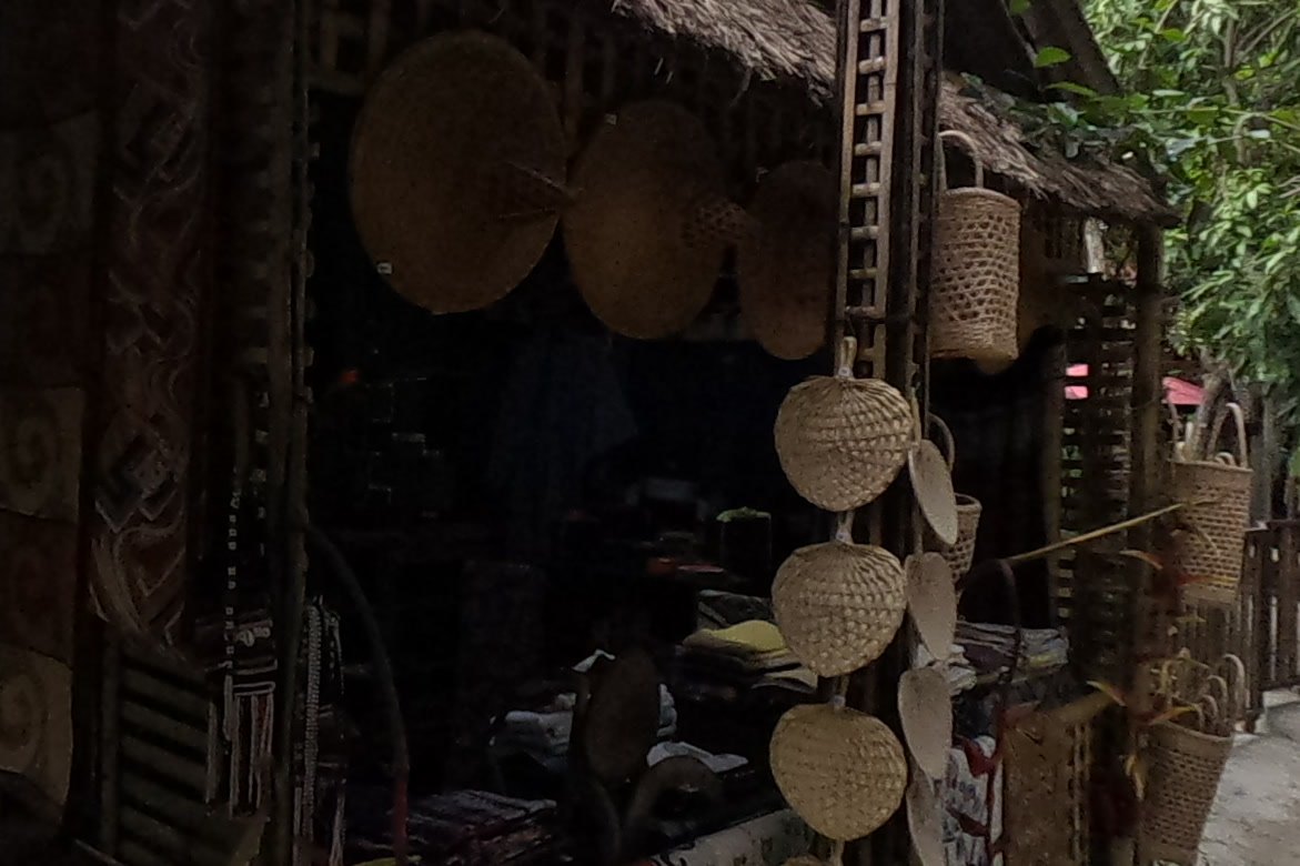 Rattan fans and straw hats at a bamboo stall — Chamcha Market, San Kamphaeng