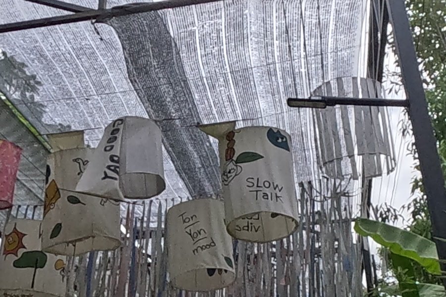 Painted cloth lanterns over the lane — Chamcha Market, San Kamphaeng