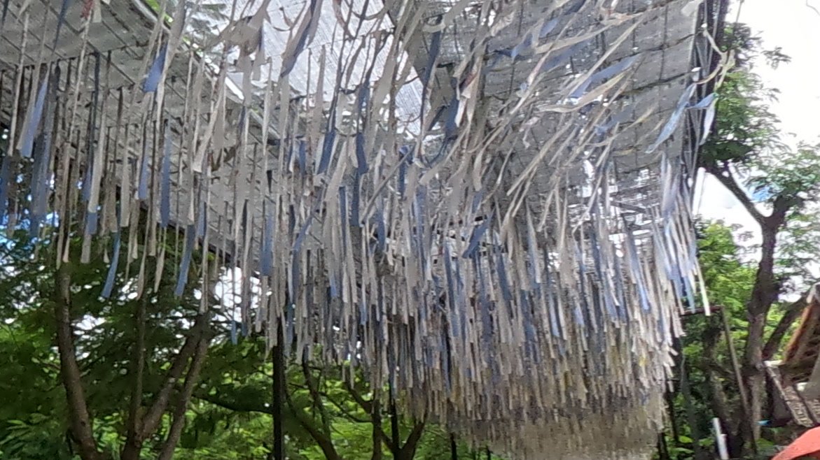 Canopy of white and blue cloth strips — Chamcha Market, San Kamphaeng