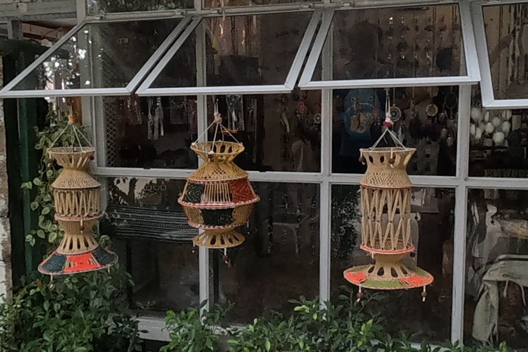Woven lanterns hanging at a shop window — Chamcha Market, San Kamphaeng