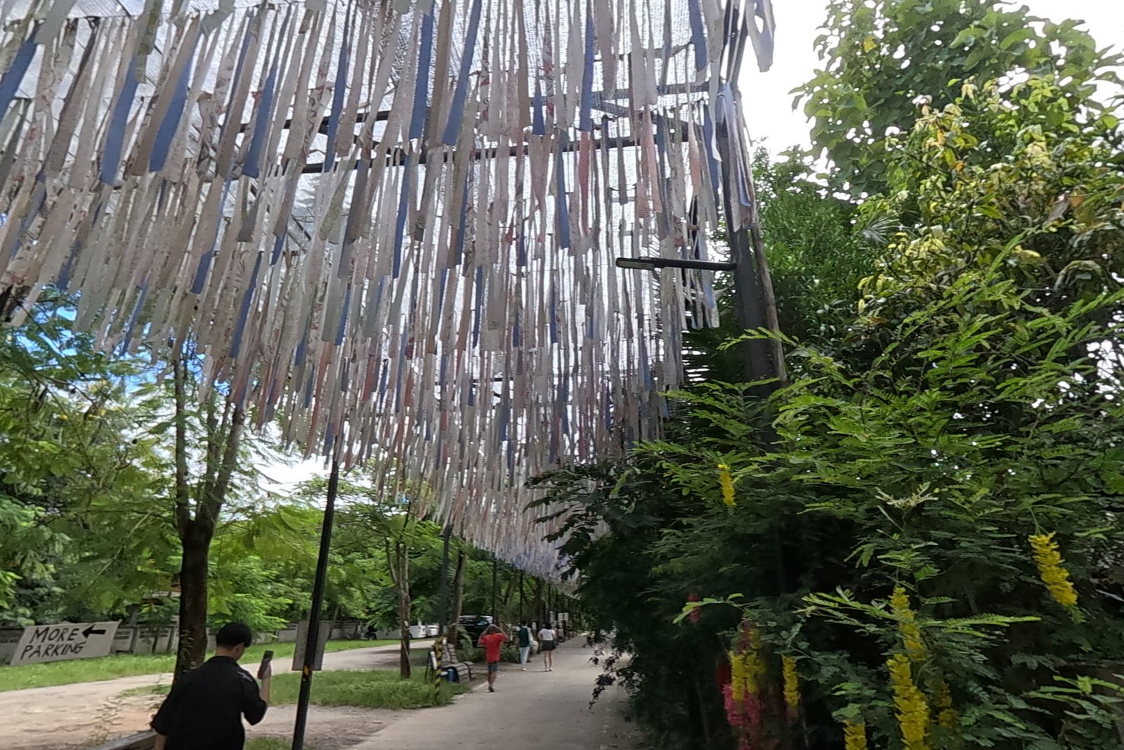 The canopy of hanging cloth strips — Chamcha Market, San Kamphaeng
