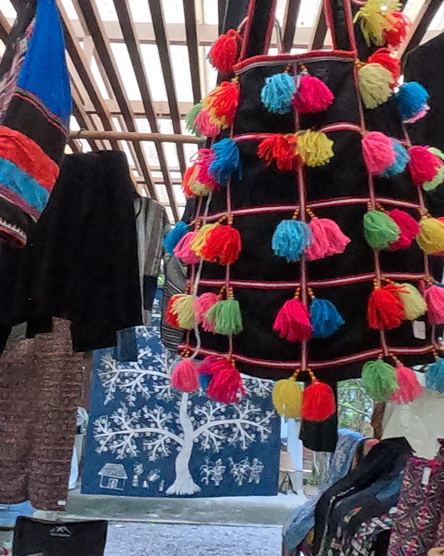 Bag hung with bright wool pom-poms — Chamcha Market, San Kamphaeng