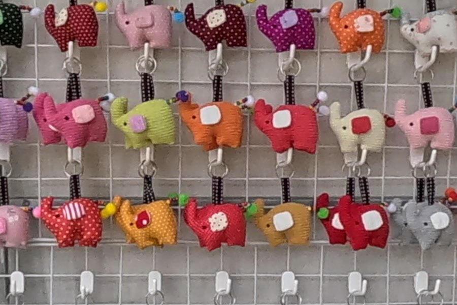 Wall of fabric elephant keyrings — Chamcha Market, San Kamphaeng