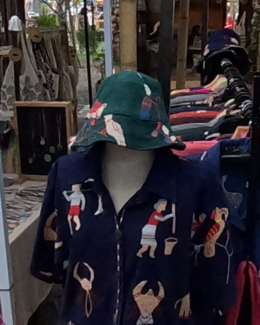 Shirt and bucket hat printed with village figures — Chamcha Market, San Kamphaeng