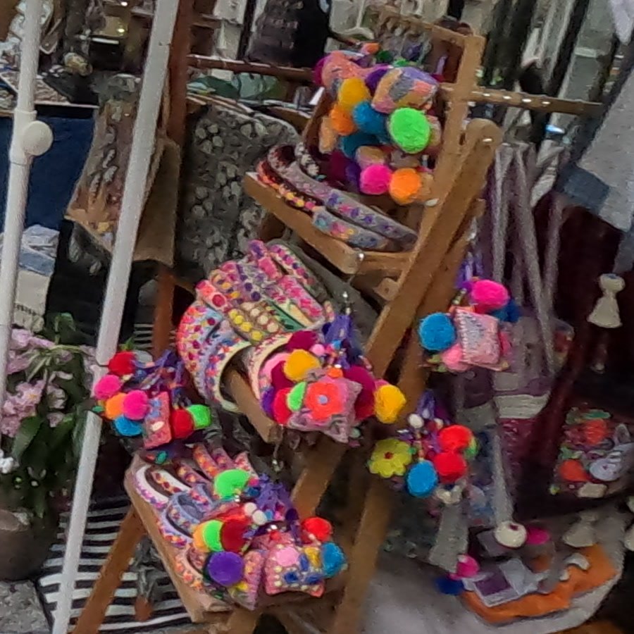 Pom-pom embroidered pouches on a ladder rack — Chamcha Market, San Kamphaeng