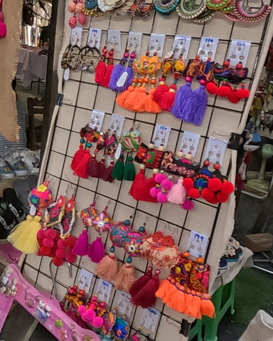 Tassel and pom-pom earrings on a pegboard — Chamcha Market, San Kamphaeng