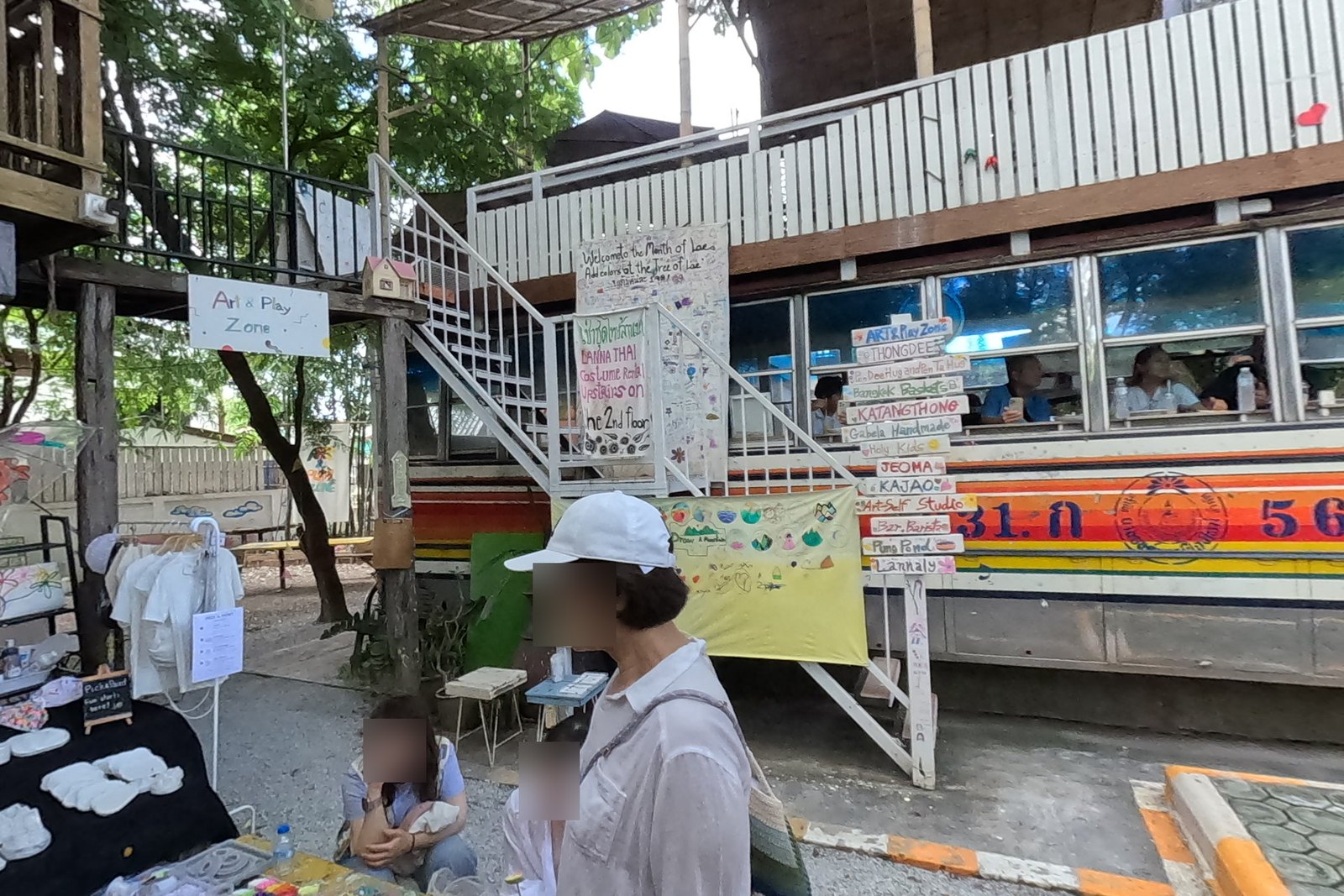 Converted bus with a painted directory — Chamcha Market, San Kamphaeng