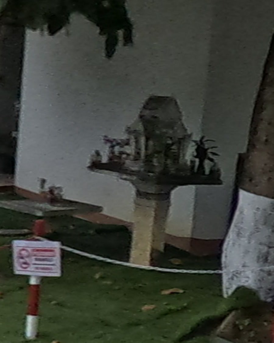 Spirit house by the white building at the car park — Chamcha Market, San Kamphaeng