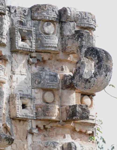 Stacked Chaac rain-god masks with long curled noses on the facade of a building at Kabah along the Ruta Puuc, Yucatan, Mexico.