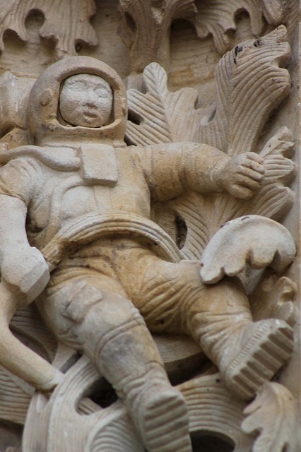The astronaut carved among oak leaves beside the Puerta de Ramos of the New Cathedral of Salamanca, a modern figure added during restoration.