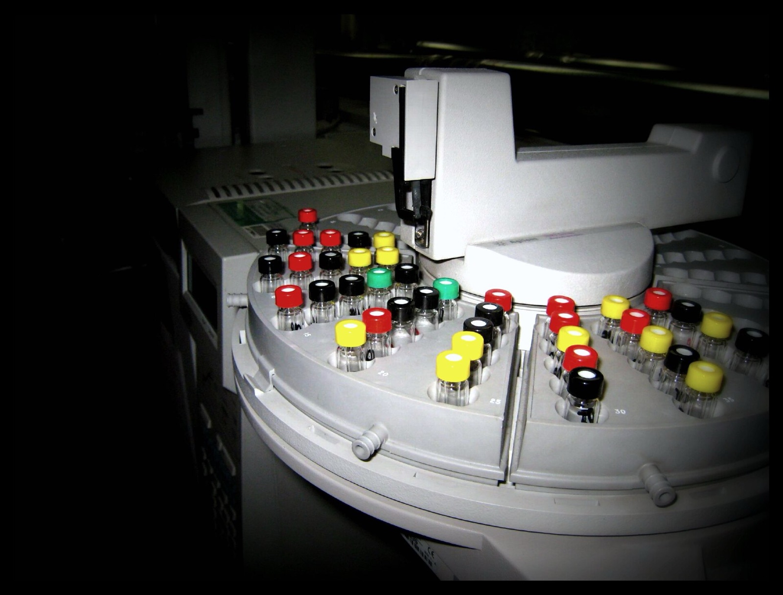 An autosampler tray: the syringe takes a drop from each vial in turn and injects it.