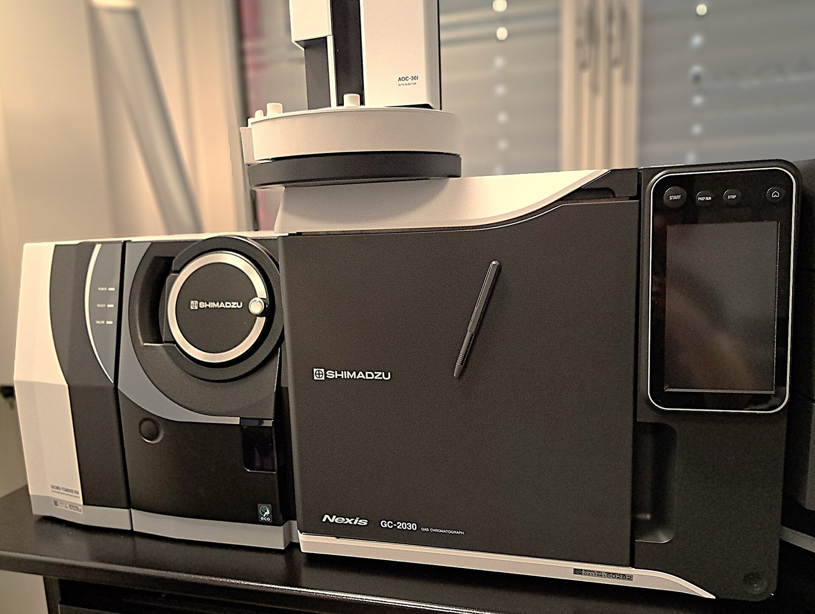 A modern benchtop GC-MS (Shimadzu): gas chromatograph on the left, mass spectrometer on the right.