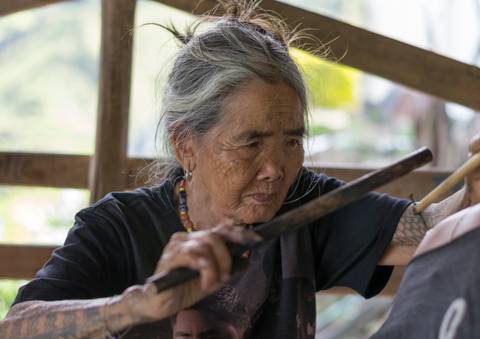 Whang-od tattooing.